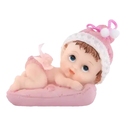 Figurina di bambina su un cuscino rosa
